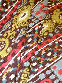 Draped curtain image of colorful railroaded stripe ikat design