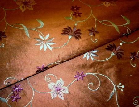 Closeup folded image of Embroidered Silk Cellini Fabric in Toast
