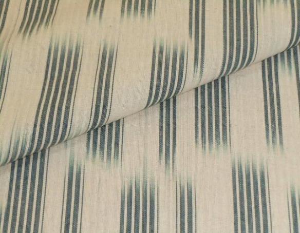 Closeup folded image of Decorator fabric in color Natural Blue Laura and Kiran Simple Spacedye