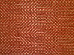 small scale gold lattice design on rust ground