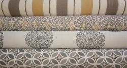 Patterns Chakra in color smoke, Granada in gray  and Alhambra in taupe,  all Hand printed geometric designs  with a coordinating woven jacquard Corsica stripe in colors taupe, gold and natural