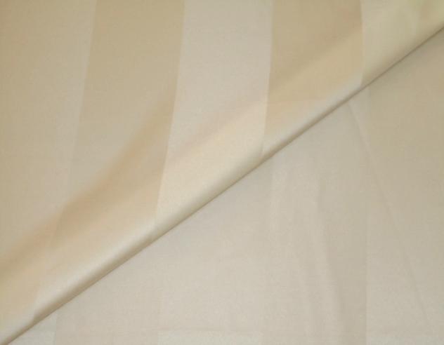 Closeup folded image of Pattern Lyon in color Ivory, Drapery weight Fabric tone on tone stripe pattern up the roll polyester cotton blend