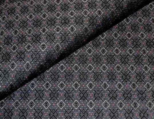 Closeup folded image of textured small geometric diamond pattern with dot accents