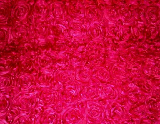 Angled image of Softline Kenington Satin F in Fuschia Rosette Drapery and Curtain Fabric on cutting table