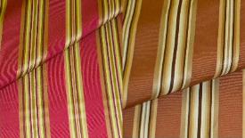 Closeup folded image of Pattern Lyndon, a Swavelle/Millcreek Upholstery Fabric, in Colors Autumn (Red) or Nutmeg (Brown)
