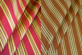 Draped curtain image of Lyndon Stripe, a Swavelle/Millcreek Upholstery Fabric in Colors Autumn or Brown, for furniture upholstering and other home decor
