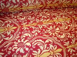 Angled image of railroaded floral medallion damask design Tantalor in Color Paprika