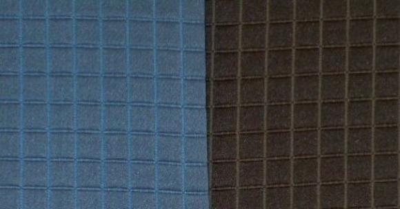Swatches of this classic textured small square diamond pattern upholstery fabric in colors Indigo (blue) Charcoal (black)