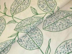 upscale decorating fabric with floral leaf embroidery on white ground
