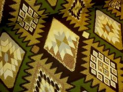 Aztec inspired diamond design in browns, tan, green and gray